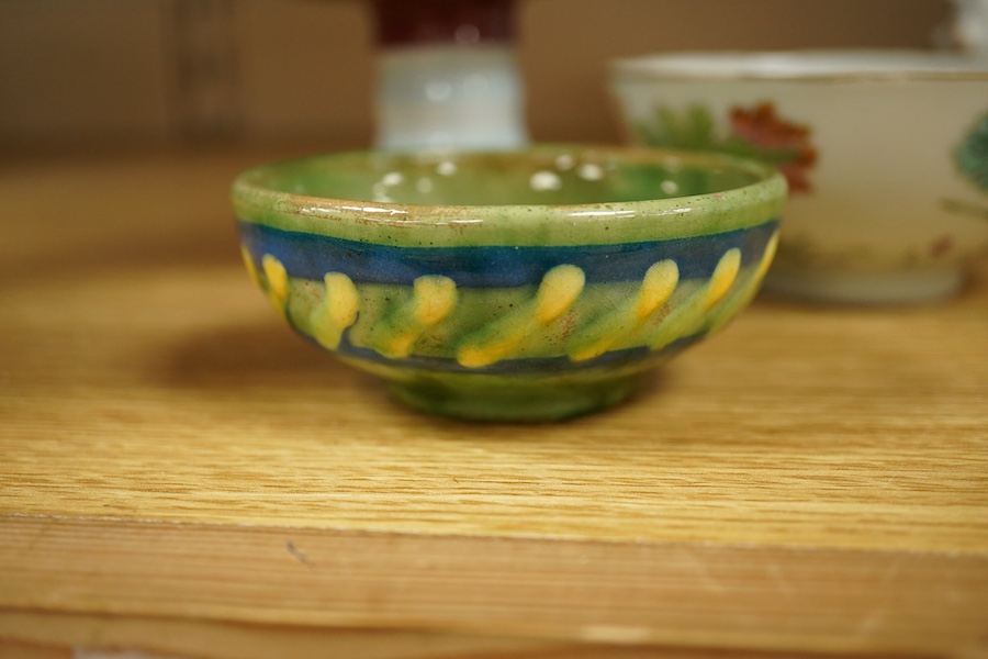 An early 20th century Chinese famille rose teapot, later famille rose teabowl, sang de boeuf stem bowl and two others, tallest 11cm. Condition - varies